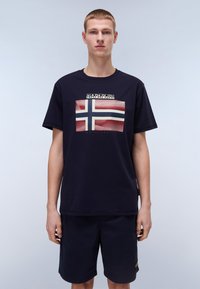 Mørkeblå T-shirt med korte ærmer, der viser et grafik af det norske flag med tekst ovenfor, lavet af et blødt bomuldsblandingsstof.
