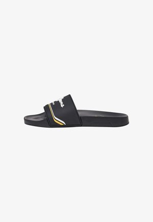 Black slide sandal with a wide strap featuring white text and yellow accents. Flat sole, made from synthetic material, with a smooth texture.