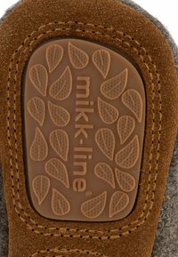 Brun gummisula med ett texturerat lövmönster och "mikk-line" logotyp; grå textil övre med en brun mockaaccent längs kanten.