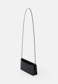 Black patent leather handbag with a rectangular shape, featuring a long silver chain strap and a flat bottom for stability.