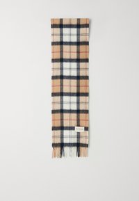 Wollen plaid sjaal met een beigem, marineblauw en wit ruitpatroon. Afgewerkt met gefranjerde randen en een klein merkje. Rechthoekige vorm.