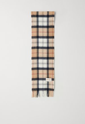 Wollschal im Karodesign mit beige, marineblauen und weißen Farbtönen. Mit fransigen Kanten und einem kleinen Markenzeichen versehen. Rechteckige Form.