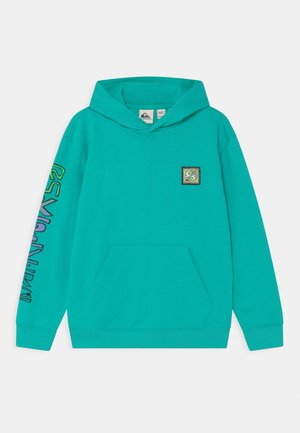 Sweat à capuche turquoise avec poche avant, petit graphique carré sur la poitrine et design de texte coloré le long de la manche gauche.