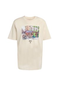 Kratka krem majica s kratkim rukavima koja prikazuje šareni grafički prikaz pariškog kafića s riječi "PARIZ" ispod u podebljanom tekstu.