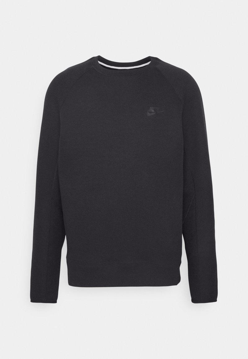 Sweatshirt noir à col rond avec des manches longues, fabriqué en tissu doux. Présente un logo Nike discret sur la poitrine. Texture lisse et design ajusté.