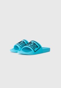 Blue rubber slide sandals with a wide strap featuring black text "FUTURE" and a textured footbed. Flat sole, open-toe design.