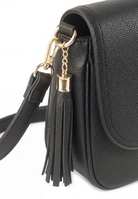 Black textured leather handbag with a detachable strap and a decorative black leather tassel attached by a gold chain and clasp.