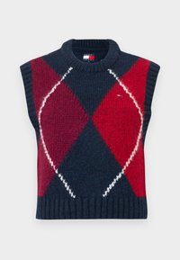 Bezrukávový sveter v námorníckej modrej, červenej a bielej farbe s vzorom argyle. Pletená štruktúra, rebrovaný výstrih a lem. Má štítok s logom.