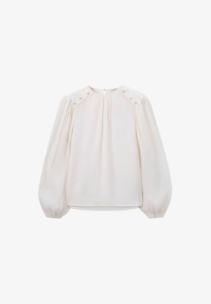 White blouse with long puffed sleeves, pleated front, button accents on shoulders, and keyhole back closure. Smooth, lightweight fabric.
