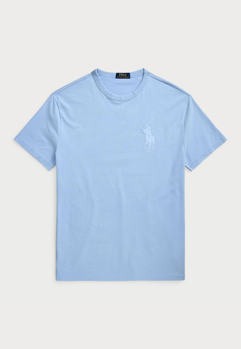 Light blue cotton t-shirt with short sleeves and a crew neckline. Features an embroidered logo on the left chest area. Smooth texture.