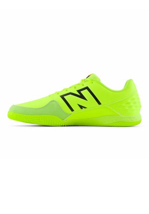 Neon green athletic shoes with a textured sole, reinforced toe, and large black logo. Features padded collar and mesh tongue for breathability.