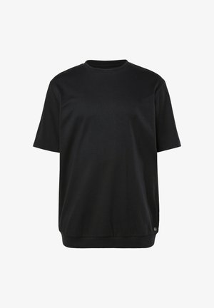 Schwarzes T-Shirt mit kurzen Ärmeln aus weicher Baumwolle. Verfügt über einen Rundhalsausschnitt und eine lockere Passform. Gerader Saum mit minimaler Detailgestaltung.
