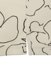 Licht beige stof met een zwart abstract bloemenpatroon. Bevat zijnaad met een lichte split aan de zoom. Zachte textuur en gemiddelde gewicht.