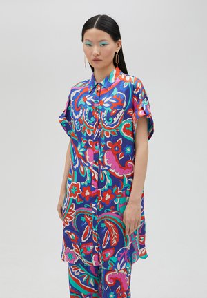 Colorful oversized button-up shirt featuring a vibrant floral and paisley pattern with short sleeves, made from lightweight fabric.
