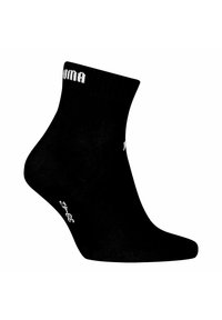 Schwarze Knöchelsocken mit geripptem Schaft und weißem Logo, ausgestattet mit einer glatten Textur und elastischer Passform für Komfort und Unterstützung.