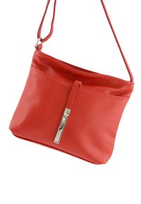 Red leather crossbody bag with a textured surface, featuring a silver-tone hardware accent and a single adjustable strap.