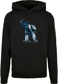 Svart huvtröja med en grafisk blå kråka och bokstaven "R" ovanför ordet "RAVENCLAW" på framsidan. Mjuk tyg, känguruficka.