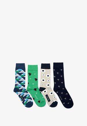 Chaussettes vertes avec des motifs de cactus en noir, avec des accents blancs et un revers côtelé. Le tissu semble lisse et extensible.