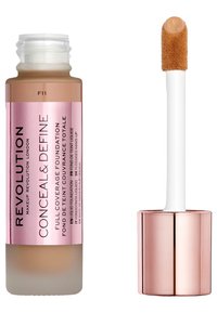 Volledige dekking foundation in een glazen fles met een roze label. Heeft een matte basis en een doe-foot applicator met een tan product.