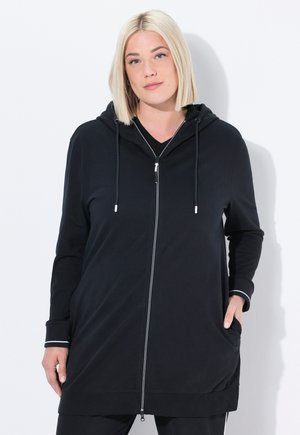 Black zip-up hoodie with a hood, long sleeves, side pockets, and white accents on cuffs; made from a soft, stretchy fabric.