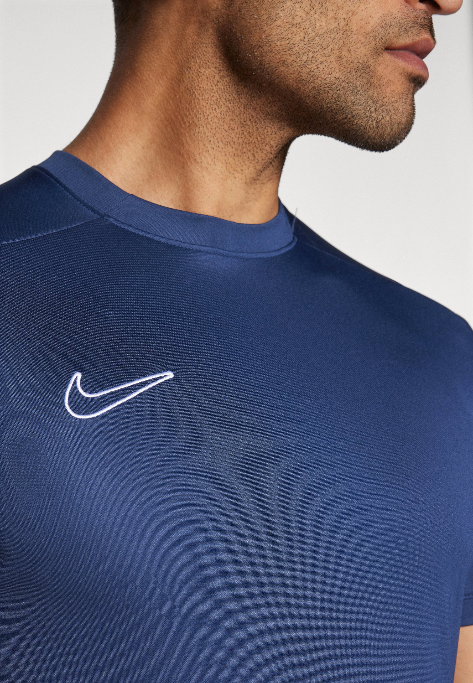 white and navy nike shirt