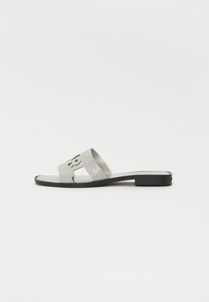 Silver glitter slide sandals with a black sole, featuring an open toe design and cut-out letters on the strap for added detail.