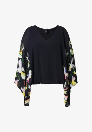 Blusa nera con scollo a V e maniche lunghe trasparenti con motivi floreali colorati in bianco, giallo, rosa e verde.