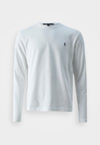 Valkoinen pitkähihainen t-paita pehmeästä puuvillakankaasta, jossa on pyöreä kaula-aukko ja pieni musta logo vasemmassa rinnassa. Yksinkertainen, klassinen muotoilu.