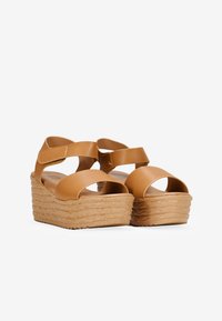 Sandali platform beige con suola in tipo juta intrecciata, dotati di due fasce larghe e chiusura in Velcro. Materiale sintetico liscio.