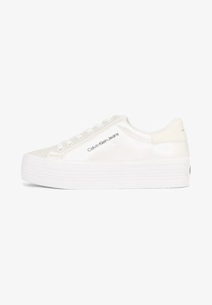White platform sneaker with thick sole, glossy finish, lace-up front, and "Calvin Klein Jeans" logo on outer side.