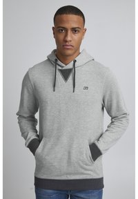 Gray hooded sweatshirt with long sleeves, front pocket, contrasting dark gray accents, and a triangular detail on the chest.