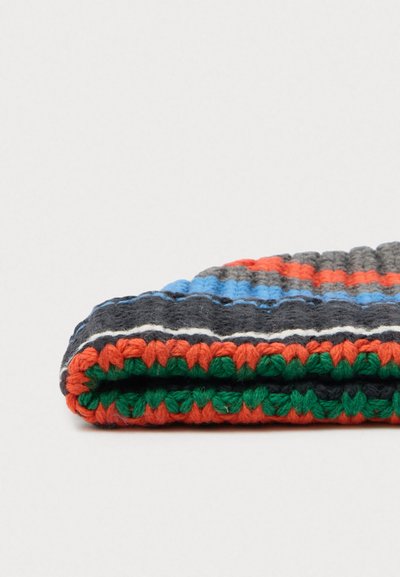 Folded knitted beanie with horizontal stripes in black, orange, green, blue, gray, and white on a white background.
