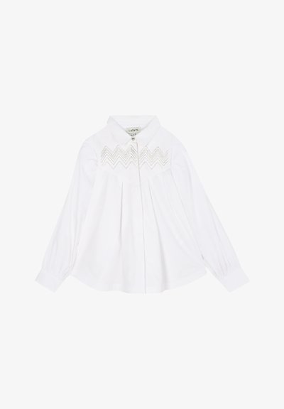 White long-sleeve shirt with a collar and zigzag embroidery detail. Features pleats and button closure at the front. Smooth fabric texture.