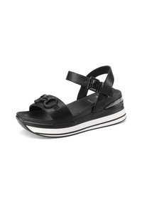 Sandalo in pelle nera con una larga fascia, fibbia regolabile alla caviglia e punta rotonda. Presenta una suola a zeppa con strisce orizzontali bianche.