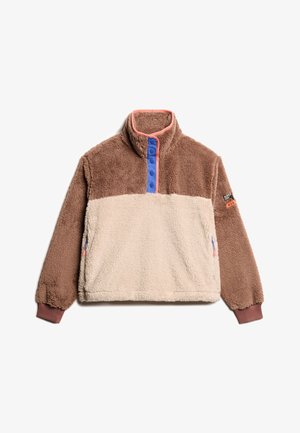 Polarowy pulower z wysokim kołnierzem, w kolorach brązowym i kremowym, z niebieskimi guzikami na zatrzaski oraz bocznymi kieszeniami, teksturowana tkanina i ściągacze przy mankietach.