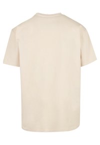 Light beige short-sleeve t-shirt made from cotton. Features a crew neckline and a relaxed fit with a smooth texture. Back view shown.