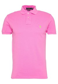 Rosa polo skjorta gjord av bomull med klassisk krage, tre-knappars placket och en liten grön broderad logotyp på bröstet.