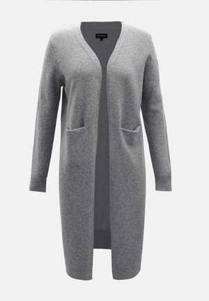 Grosse cardigan grise en matériau doux, avec un col en V, des manches longues, une ouverture à l'avant et deux poches sur le devant. Poignets et ourlet en tricot texturé.