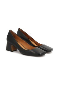 Scarpe col tacco alto in pelle nera con punta quadrata e tacco a blocco. Texture liscia con una silhouette affusolata e una soletta imbottita.