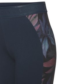 Navy leggings featuring a floral pattern in shades of purple and green on the side, with a textured waistband and smooth fabric finish.
