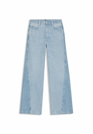 Jeans a gamba larga di un blu chiaro con un design bicolore, caratterizzati da una texture leggermente sbiadita e dettagli con orlo sfrangiato alle gambe.
