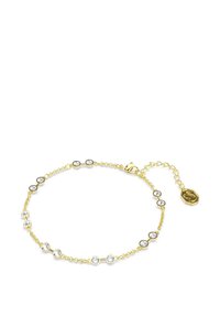 Guldkedja armband med runda klara stenar i svart och guld accenter, med ett justerbart lås och en liten logocharm.