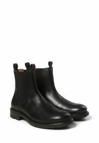 Bottines en cuir noir avec des accents de couture, des panneaux élastiques sur les côtés et des languettes de tirage. Bout arrondi et semelles en caoutchouc texturé.