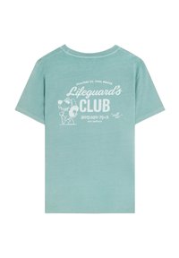 Licht teal katoenen T-shirt met een grafische print van een hond met een zonnebril, de tekst "Lifeguard's Club" en een contactnummer in het wit.