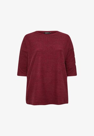 Burgunderfarbener Kurzarm-Top aus einem weichen, strukturierten Stoff mit lockerer Passform und drei dekorativen Knöpfen an jedem Ärmel. Runder Ausschnitt.