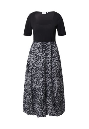 Black top with short sleeves and a square neckline, paired with a gray, leopard-print skirt. Material appears smooth and flowing.