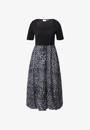 Black top with short sleeves and a square neckline, paired with a gray, leopard-print skirt. Material appears smooth and flowing.