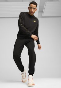 Puma MINIMAL GOLD JOGGING - Pantalones deportivos - black