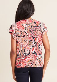 Multikleurige blouse met korte mouwen, voorzien van een opvallend paisleypatroon in tinten van rood, roze en marineblauw, met kanten details op de schouders.