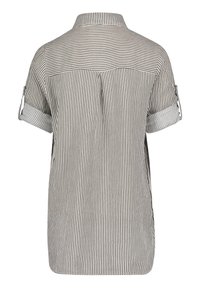 Maglietta a maniche corte a righe bianche e nere, con colletto, maniche arrotolabili e una piega sul retro per un tocco di design. Tessuto di cotone.